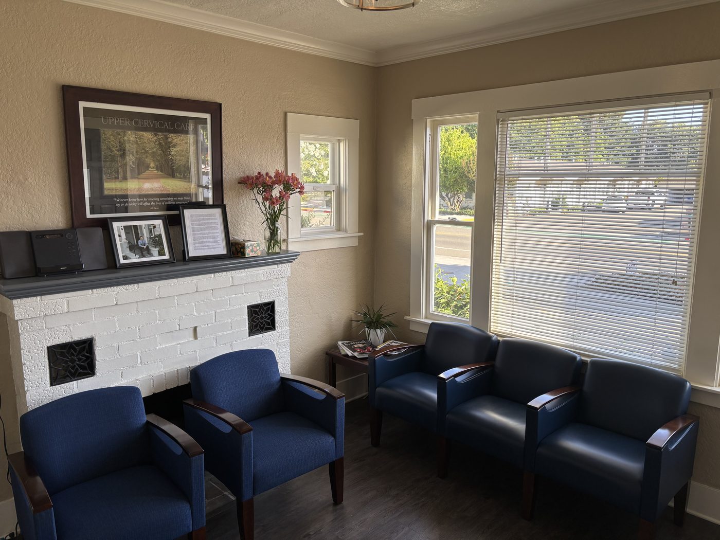 Waiting area with a fireplace and large windows