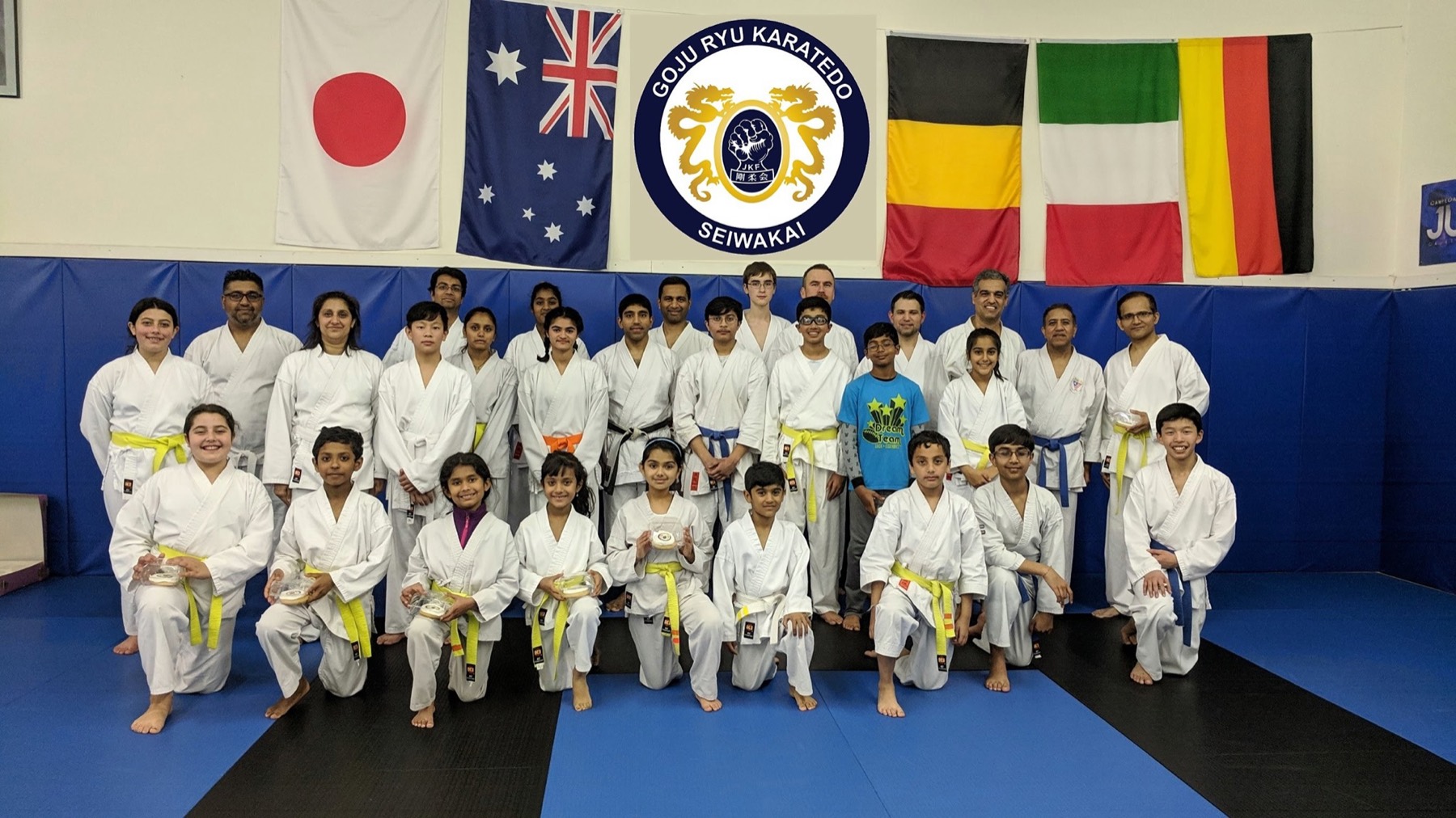Tri-Valley Karate students and instructors lined up in white uniforms in the Pleasanton dojo